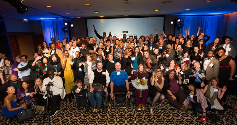 over 100 artists posing for a photo at the 10th annual 3Arts Awards