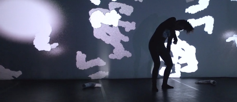  Person dances with grey and white image projected over them 