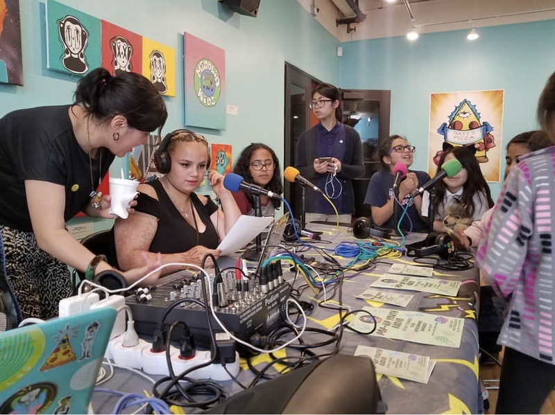  group of people sit around table working on project 