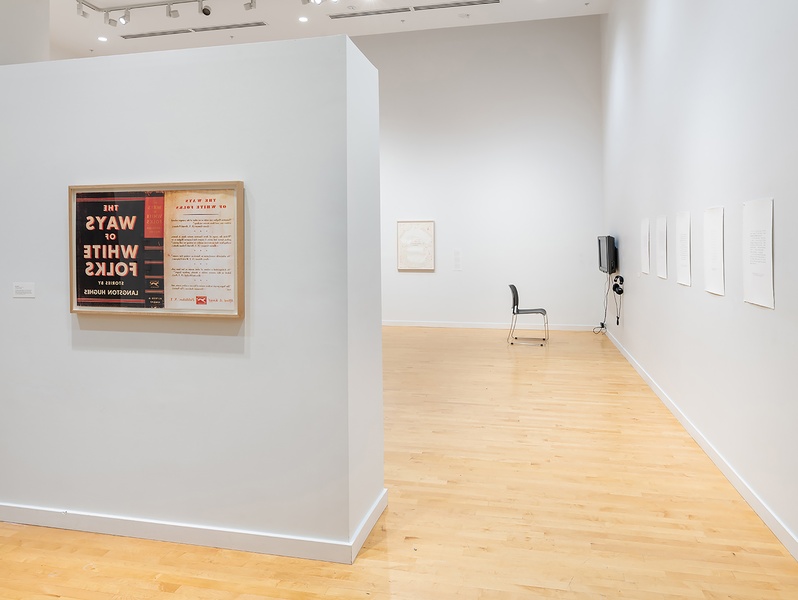 on left wall, a framed silkscreened print based on a dust jacket from the 1963 edition of Langston Hughes’ The Ways of White Folks, originally published in 1934. The print is “flipped” so that it reads backwards, a kind of mirror image to viewers.
