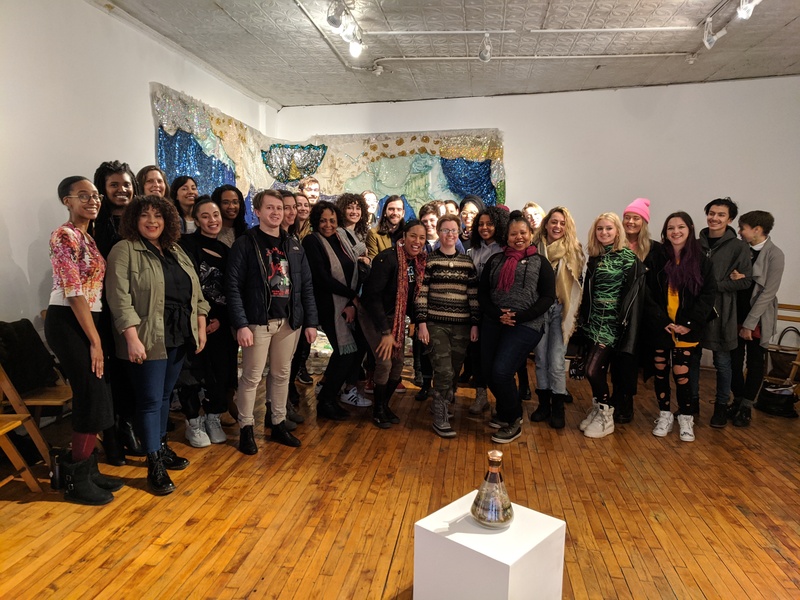  31 people dressed in warm winter clothing and coats gathered in the Heaven Gallery space, posing for a group photo after Rhonda's 'Manifesting' workshop 