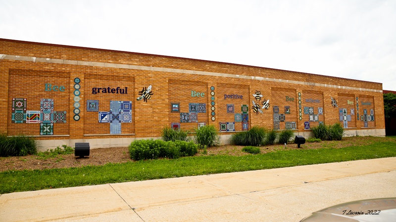  Image of brick building with mosaics patterns on long wall. 