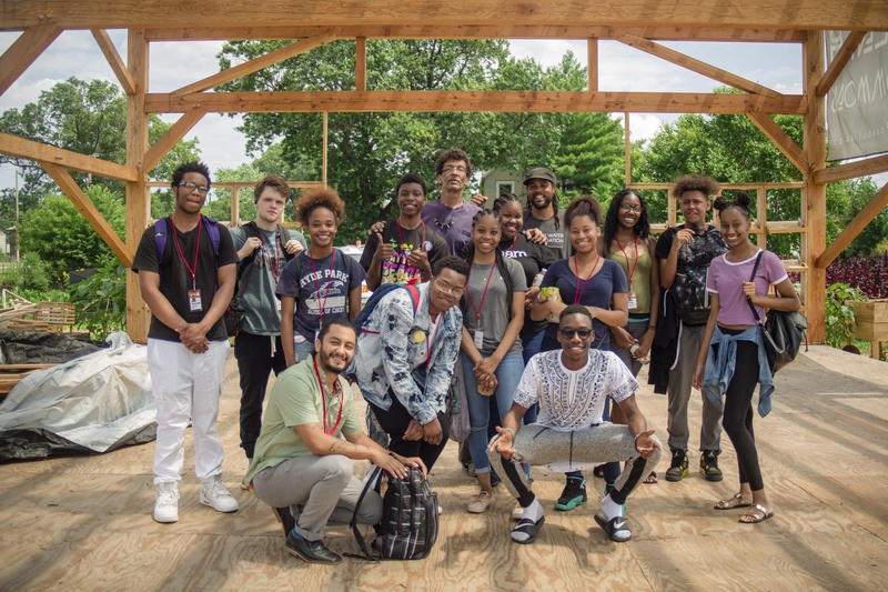  Artist Luis Sahagun and a smiling group of thirteen students pose for the camera during a study trip to Sweet Water Foundation. 