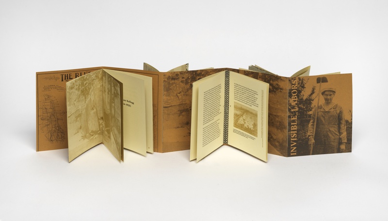 A full fold-out of an accordion style book with a gold cover, handmade paper showing the interior of the publication 