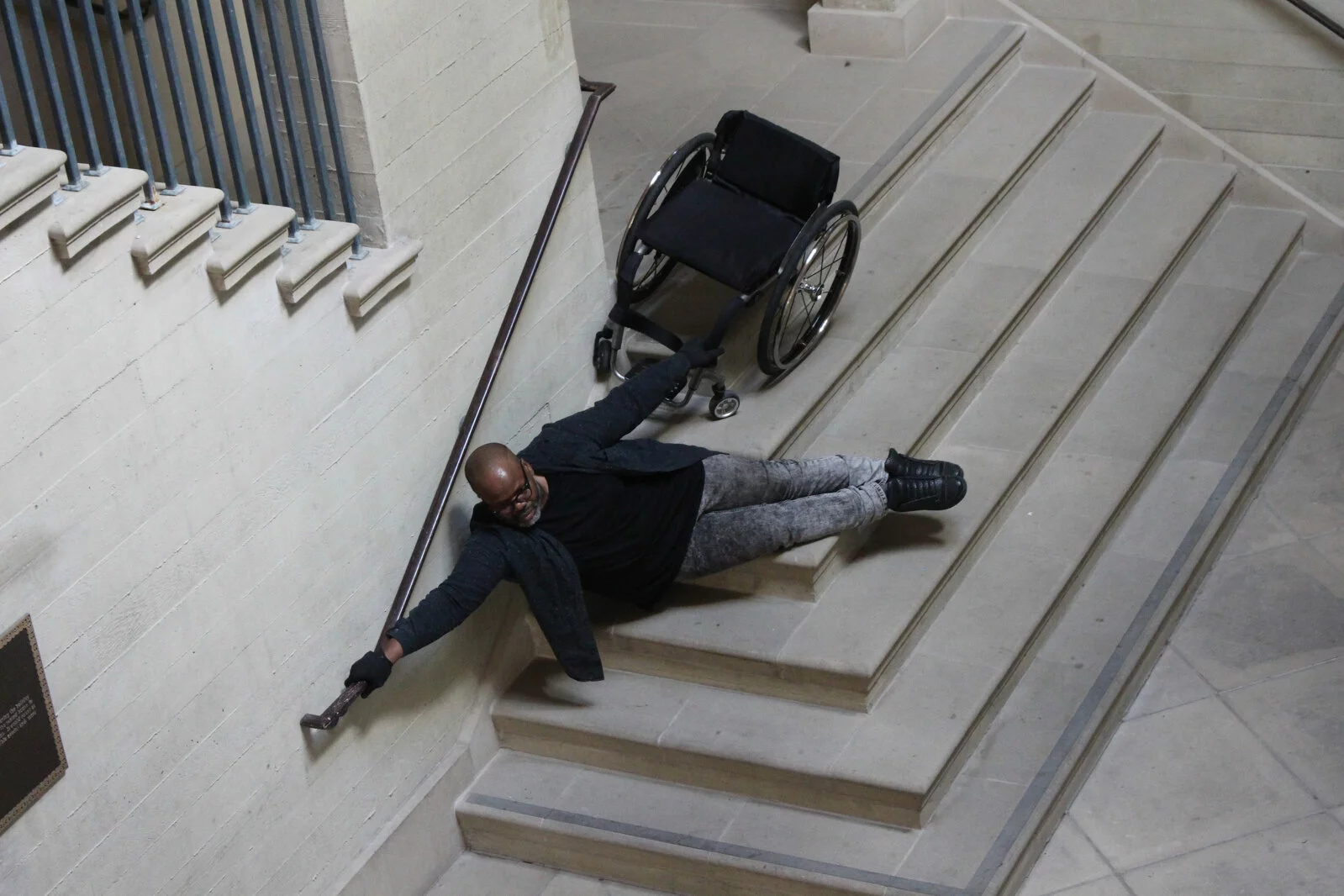 Barak holding onto his wheelchair while on stairs for A-Series of Movements.