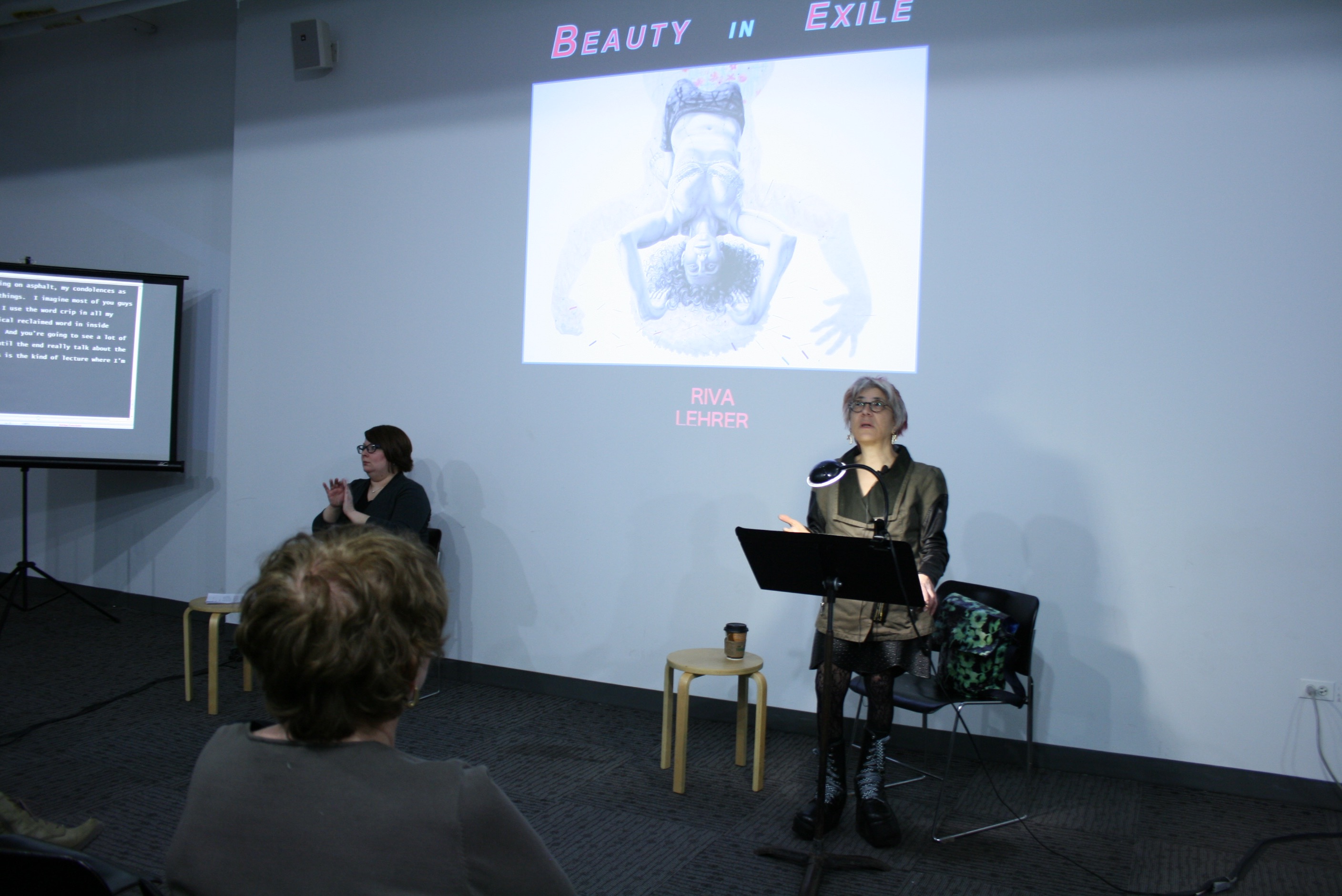 Riva giving a presentation titled Beauty in Exile.